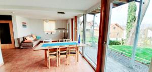 a dining room with a table and a living room at Bocasa Bodman in Bodman-Ludwigshafen