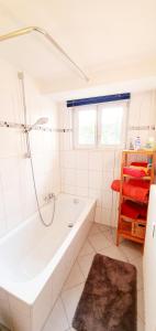 a white bathroom with a tub and a shower at Bocasa Bodman in Bodman-Ludwigshafen