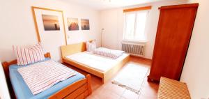 a bedroom with a bed and a couch and a window at Bocasa Bodman in Bodman-Ludwigshafen