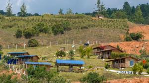 a group of houses on top of a hill at Glamping Isaju , Santa Helena , Valle del Cauca in El Cerrito