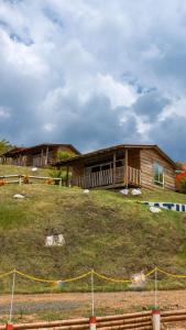 a house sitting on top of a hill at Glamping Isaju , Santa Helena , Valle del Cauca in El Cerrito