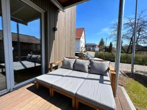 a bench on the back of a porch at Landhaus zum See - Fewo Birke in Überlingen