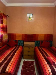1 dormitorio con 2 camas y vestidor en RIAD Anis en Marrakech