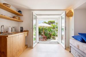 una cucina con porta aperta che conduce a un patio di Villa Cisterna Capri, private beach front property with pool a Capri Altre 28 foto