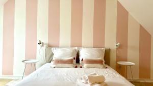 a bedroom with a bed with striped walls at Le Terracotta in Nevers