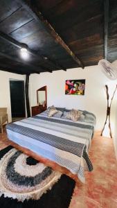 a bedroom with a large bed in a room at Cabaña la roca de minca sierra nevada in Santa Marta