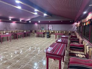 a restaurant with tables and chairs in a room at Dream Bedouin life camp in Wadi Rum