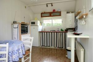 アゴン・クタンヴィルにあるMaison d'une chambre a Agon Coutainville a 800 m de la plage avec terrasse et wifiの小さなキッチン(テーブル、冷蔵庫付)