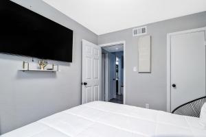a bedroom with a flat screen tv on the wall at Cozy home away from home (U) in Norfolk