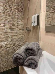 a bathroom with a shower with towels on a sink at Bermudo III VUT-LE-784 in León