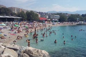 a group of people in the water at a beach at Apartments Urban in Split