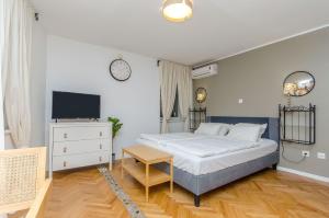 a bedroom with a bed and a television in it at Apartments Urban in Split