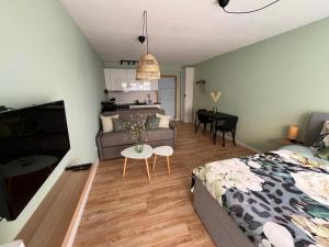 a bedroom with a bed and a living room at Studio MANI in Ostend +35 photos