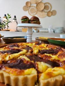 uma pizza sentada em cima de uma mesa com sanduíches em Pousada Menino de Ouro em Penedo