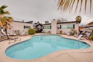 a large swimming pool in front of a house at Pet-Friendly Las Vegas Home Shared Pool and Hot Tub in Las Vegas