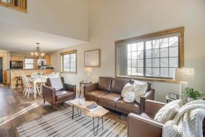 a living room with a couch and a table at Nisswa Townhome with Boat Slip and Gull Lake Access! in Nisswa