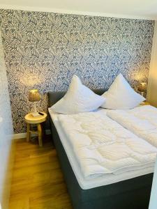 a bed with two pillows on it in a room at Ferienwohnung Watten im idyllischen Pruchten in Pruchten