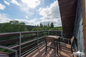 a balcony with a table and a chair on it at Auszeit im Harz - Haus 2 Wohnung 5 in Schierke