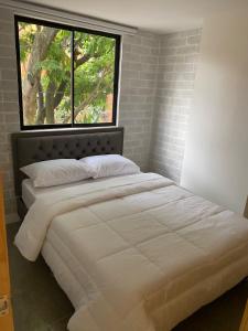 Postel nebo postele na pokoji v ubytování Edificio Helena