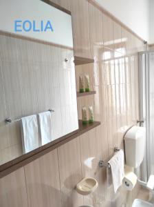 a white bathroom with a toilet and a mirror at Holiday home Mennulita in Lipari