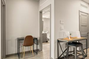 a room with a table and a chair and a mirror at Stunning Westgate CozySuites by stadium with pool 5 in Glendale +27 photos