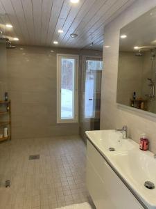 a bathroom with a sink and a mirror at Beautiful house in peaceful area in Vantaa