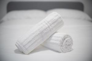 a roll of white toilet paper sitting on a bed at Beautifully Renovated 3BR Downtown 2min to METRO in Montréal