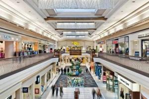 a large shopping mall with people walking through it at Stylish 2BR: w/free parking & streaming! in Pickering