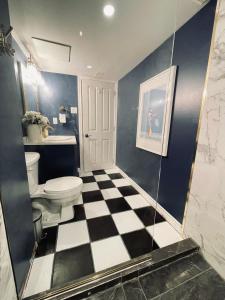 a bathroom with a toilet and a checkered floor at Golf Viwe house in Ottawa