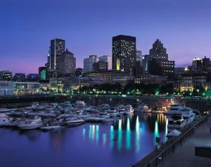 a group of boats docked in a harbor at night at Cozy haven near Olympic Park, Pac-Man Arcade Game in Montreal