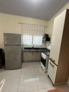 eine Küche mit einem Kühlschrank aus Edelstahl und einem Fenster in der Unterkunft Flat próx. Rodov. e Aeroporto in Palmas
