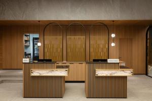 a lobby with wooden counters and a row of doors at Courtyard by Marriott Cluj - Napoca Downtown in Cluj-Napoca