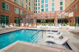 a large swimming pool with chairs in a building at SpringHill Suites by Marriott Greenville Downtown in Greenville