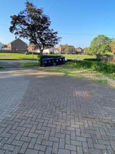 a brick road with a bunch of trash cans at In Royal Leamington Spa 4 bed with free parking in Leamington Spa