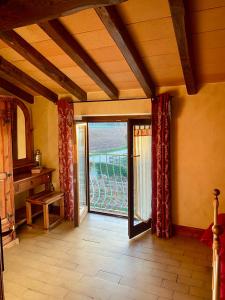 a room with an open door to a balcony at La Locanda Del Tevere in Fiano Romano
