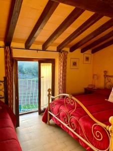 a bedroom with a red bed and a large window at La Locanda Del Tevere in Fiano Romano