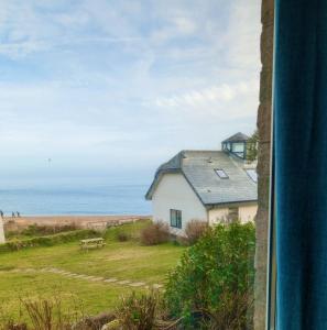 a house with a view of the beach at Beach Front Coastal Retreat with Sea Views in Kingsbridge