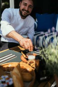 a man sitting at a table with a plate of food at MARITTIMO Milano Marittima in Milano Marittima