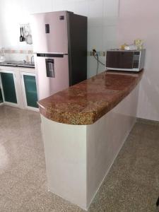 a kitchen with a white refrigerator and a microwave at Preciosa casa totalmente amueblada y equipada. in Veracruz