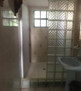 a bathroom with a shower and a sink at Coconut Tree West End in West End