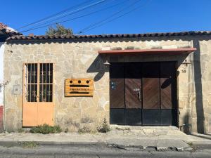 a building with two doors and a sign on it at 13 Cielos Hostel in San Cristóbal de Las Casas