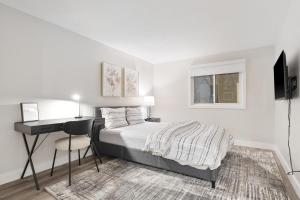 a bedroom with a bed and a desk with a computer at 14 minutes from downtown, brand new home in Ottawa in Ottawa