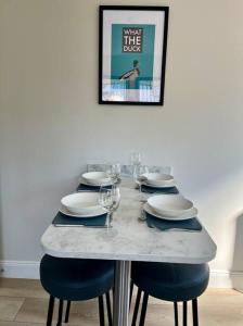 a table with plates and wine glasses on it at Cragside in Callander