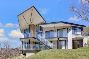 a house on top of a hill at Smugglers Lodge - Luxury Ski In Ski Out Experience in Smiggin Holes