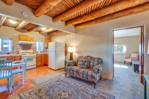 a living room with a chair and a refrigerator at Quiet Mora Hideaway 35 Mi to Angel Fire Resort! in Cleveland