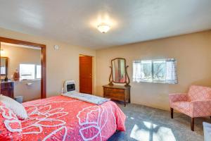 a bedroom with a bed and a mirror and a chair at Quiet Mora Hideaway 35 Mi to Angel Fire Resort! in Cleveland
