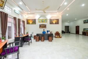 a lobby of a hotel with a man sitting at a counter at Damnak Soksan Hotel in Siem Reap