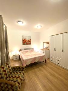 a bedroom with a bed and a chair in it at Little villa Tony- Center 40m beach Crikvenica in Crikvenica