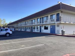 a building with a car parked in a parking lot at Motel 6-Reno, NV - Livestock Events Center in Reno