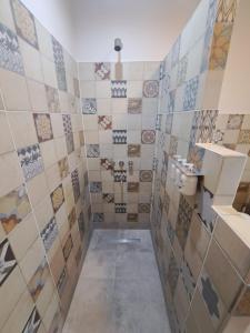 a tiled bathroom with a sink and a toilet at Complejo Pino Azul in General Roca